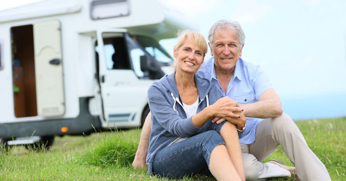 older couple in front of rv